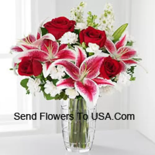 ورود حمراء، زنابق وردية مع أزهار بيضاء متنوعة في فازة زجاجية